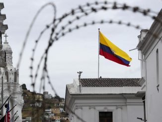 An Ecuadorian flag waves at the government palace in Quito