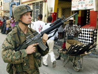 U.S Marines patrol in Port au Prince, March 15, 2004. U.S. troops suffered their first casualty in Haiti when a Marine was injured by gunmen as the poor Caribbean country's new leader protested a visit to the region by ousted President Jean Bertrand Arist