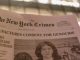 A new york times satire paper titled new york crimes is raised in a demonstration