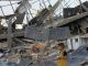 Children stand with bombed solar panels in gaza