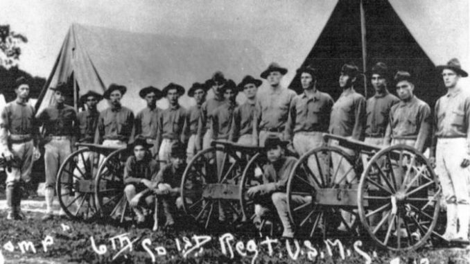 US Marines in 1915 posing with wheeled guns 696x392