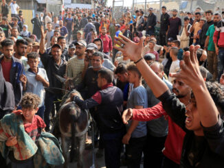 People react as Palestinian casualties, who were waiting to receive aid, are brought into Nasser hospital following an Israeli strike, in Khan Younis