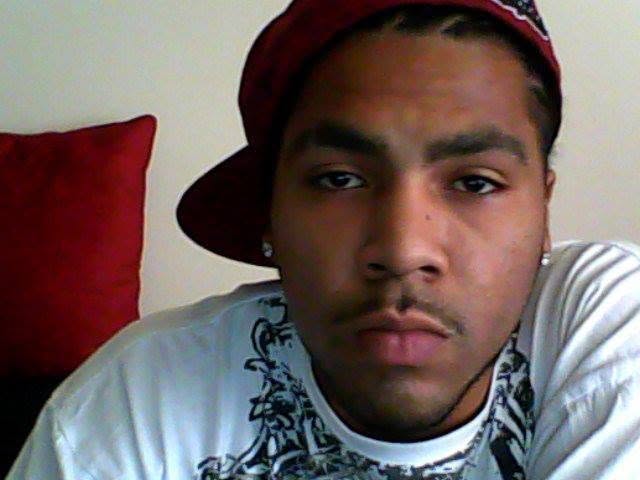 Photo portrait of Corey Ruiz in a baseball cap