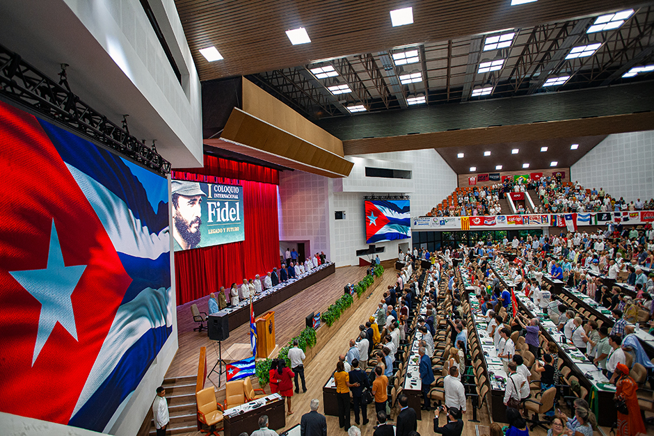 Photo shows packed auditorium in Havana for the International Colloquim in honor of Fidel’s 100th birthday